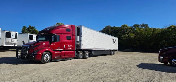 A truck with TVA Logistics branded trailer