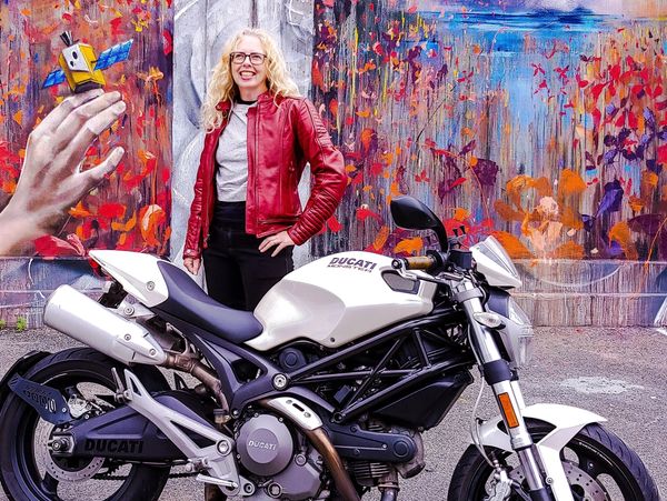 women with a Ducati Monster motorcycle by wall mural