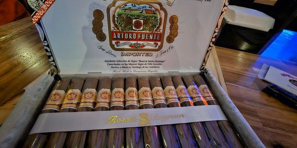 Box of Arturo Fuente cigars arranged neatly.