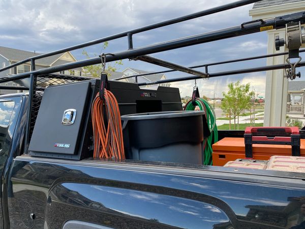 Pick up truck toolbox installed with a ladder rack