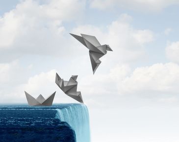 Origami bird flying off a waterfall.