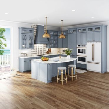 Modern kitchen with blue cabinets, white countertops, and gold accents.