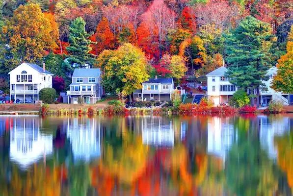 River front cottages surrounded by fall colors on an American river cruise from the USA to Canada.