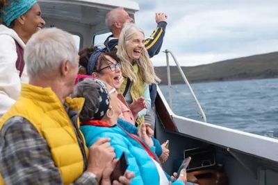 A group of passengers on a cruise shore excursion in the waters of the Inside Passage in Alaska.