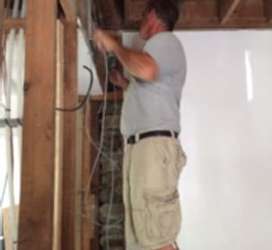 a man working on a ceiling in a house