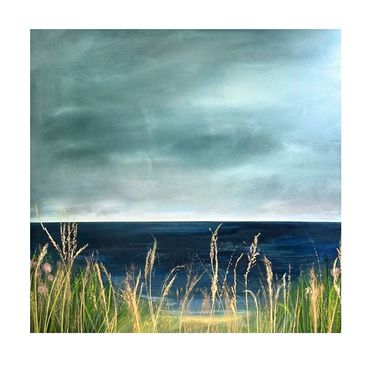 Serene coastal view with tall grasses and a calm sea under a moody sky.