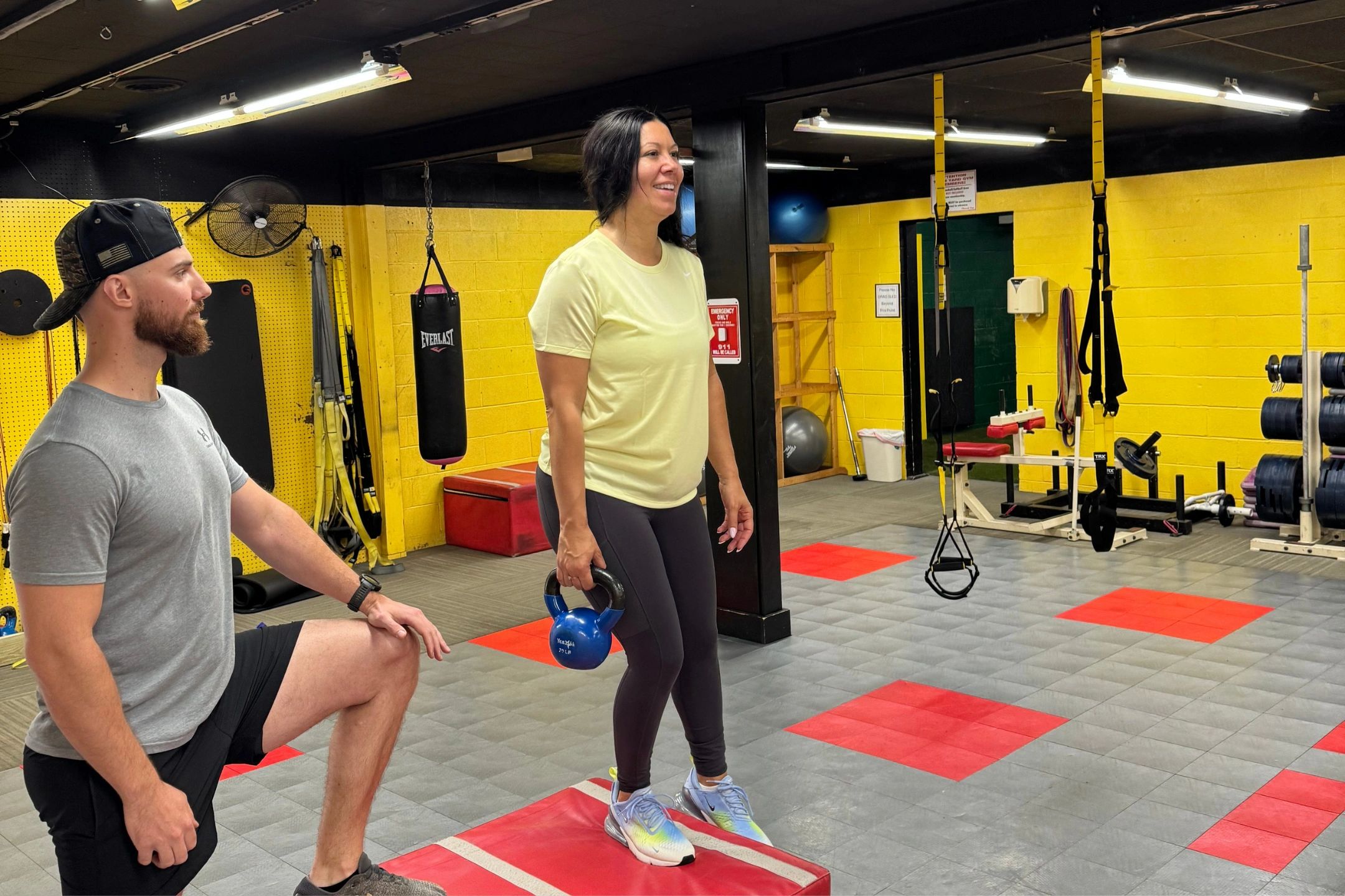 Personal trainer coaching a client through kettlebell exercises at Train Yard Gym in Harrisburg PA