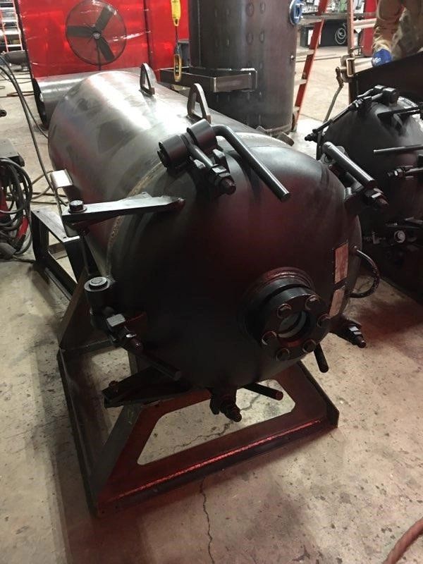 24 inch manway access door mounted on a horizontal pressure vessel. Closure includes sight glass