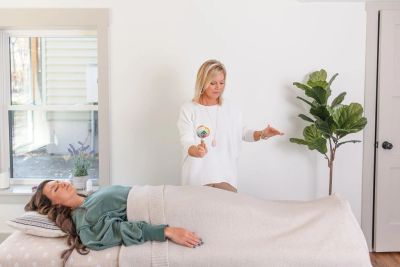 Woman receiving energy healing.