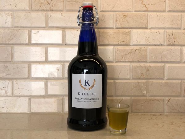 Kollias Extra Virgin Olive Oil 1L bottle with shotglass of green agourelaio olive oil