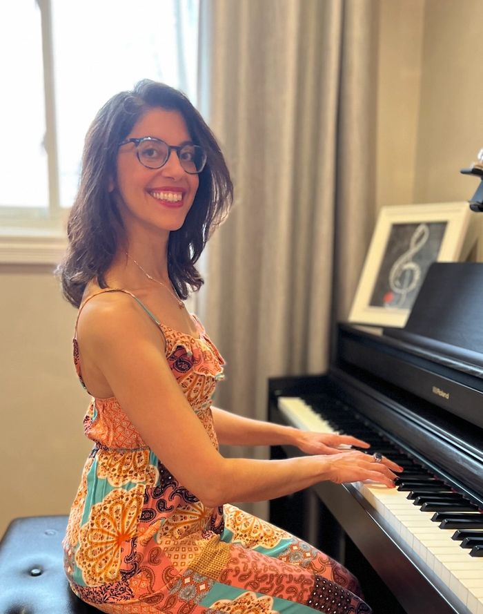 Ms Nefeli sitting at the piano