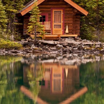 Cozy wooden cabin by a calm lake surrounded by evergreen trees. Grand Rapids, MN