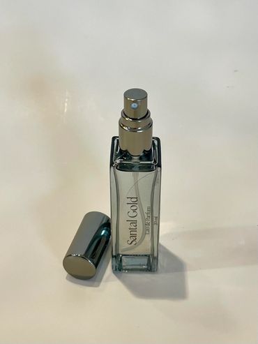 Sandal Gold perfume spray bottle with silver cap removed.