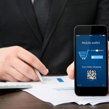 Businessman shows a mobile wallet app on smartphone for online shopping.