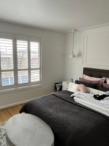 his bedroom now enjoys enhanced comfort and privacy with our custom-fitted plantation shutters. The