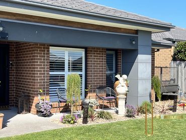 Elegant plantation shutters add timeless style and privacy to both the master bedroom and the home's