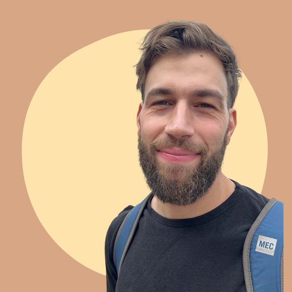 Man smiling with backpack.