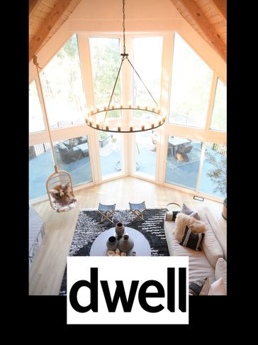 A sky view of a large prowl window and a living space with a lit chandelier