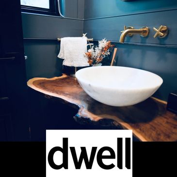 A white bathroom sink on a wood counter.