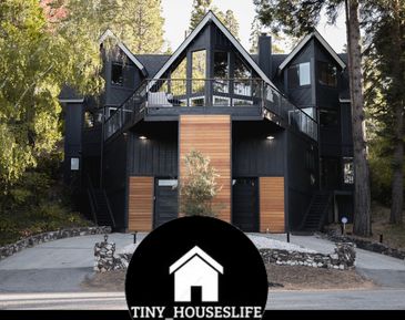 A black Prowl home with tall trees.