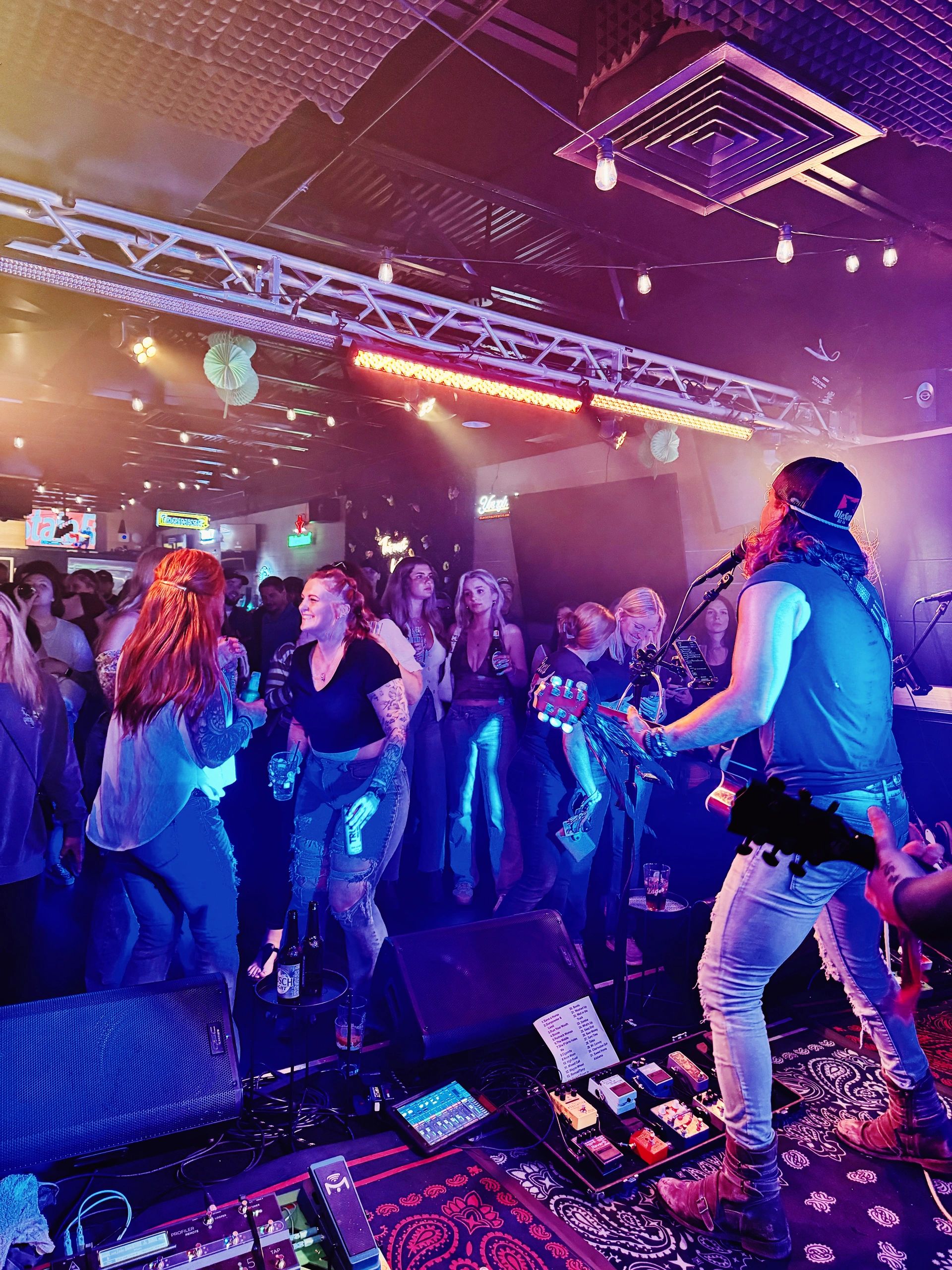 Energetic live music performance with a crowd enjoying the vibrant atmosphere.