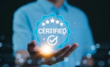 Person holding a glowing holographic certified badge with stars and checkmark.