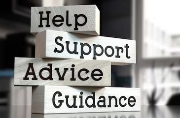 Wooden blocks with words Help, Support, Advice, and Guidance stacked.