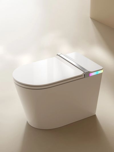 Modern white smart toilet with LED lighting.