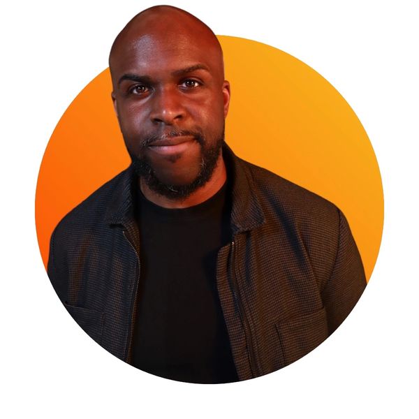 Selfie of Ryan Dennis smiling with a orange gradients circle behind him