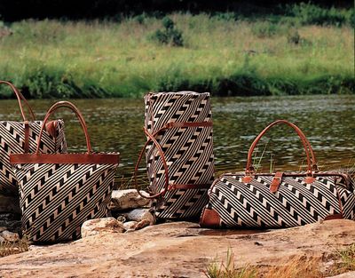 Group of travel bags with an Anasazi  patterned print.