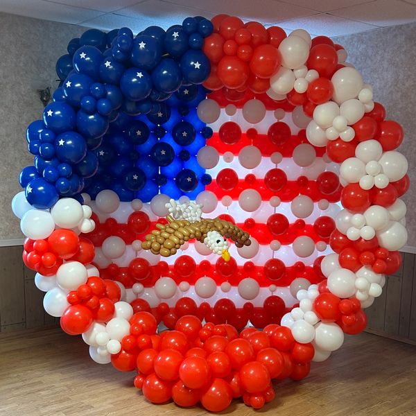 A patriotic balloon arrangement resembling the American flag with an eagle in the center.