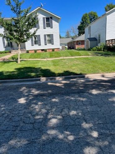 finishing up lawn mowing on the block for the day.