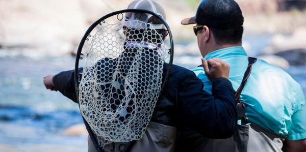Image of two men talking about fishing.