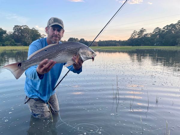 Steve is an avid fisherman, pictured here with a redfish on the Edisto River
