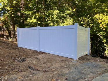 White vinyl fence in backyard