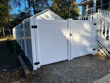 White vinyl fence with entry gate