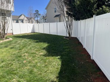 White vinyl fence in backyard