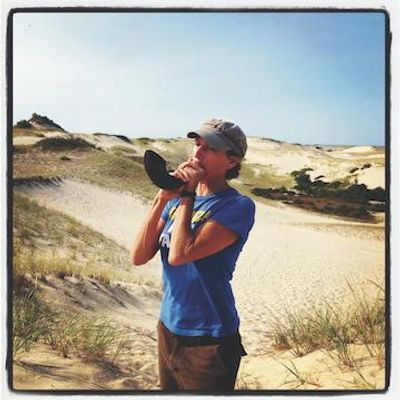Zoë Lewis blowing her shofar in the Provincetown dunes, 2012
