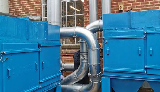 Two dust extraction units connected to a centralised dust extraction system.
