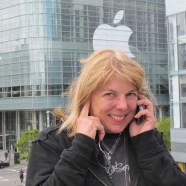 Carol Sconzert on mobile phone in front of Moscone Convention Center