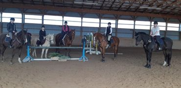 A group riding lesson in the indoor arena