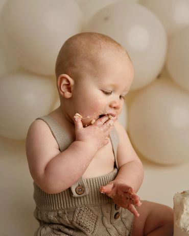 baby eating cake at cake smash session