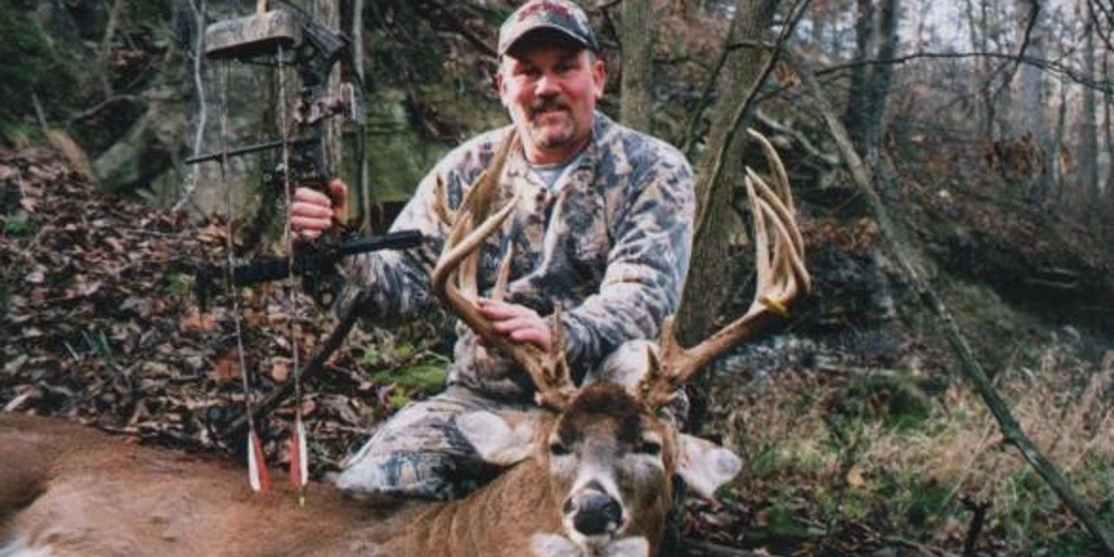 Joe Cochrane, owner of Nature's Image Taxidermy, holding a trophy whitetail buck shot with his bow.