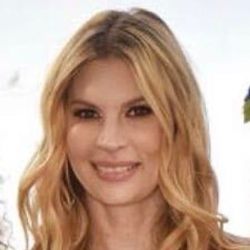 Blonde woman smiling at the camera.