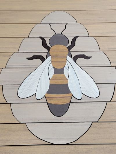 Inlay of a bee in TimberTech decking