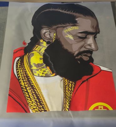 Artistic portrait of a man with elaborate tattoos and a red garment.