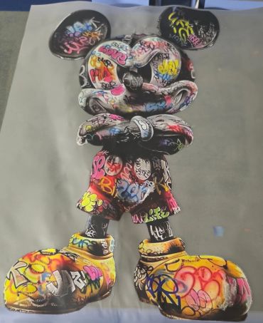 Graffiti-covered Mickey Mouse statue.