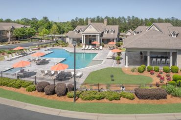 Resort-style outdoor pool with lounge chairs and clubhouse at Greystone at Riverchase