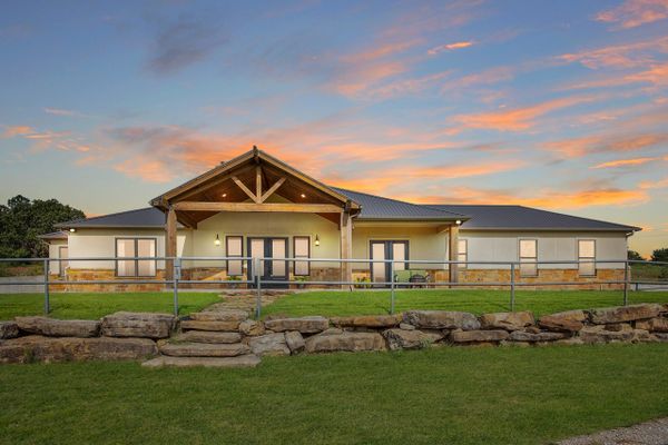 a ranch house with sunset