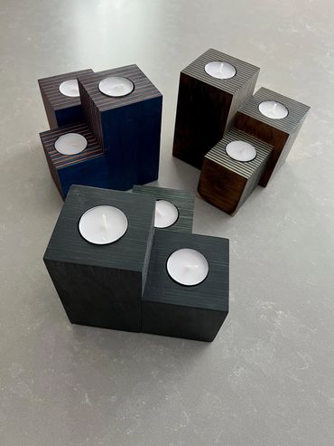 Modern wooden candle holders with white tea light candles.